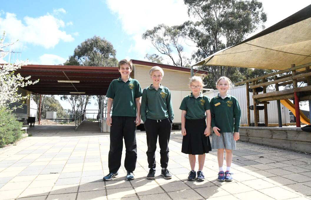 Eppalock Primary School students Will, Reuben, Annika and Annemieka in front of the old toilet block that will make way for a natural play space. Picture: Adam Holmes