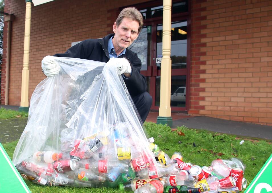 Greens candidate for Bendigo West Laurie Whelan with the bottles and cans he collected from CBD waste bins last night. Picture: GLENN DANIELS