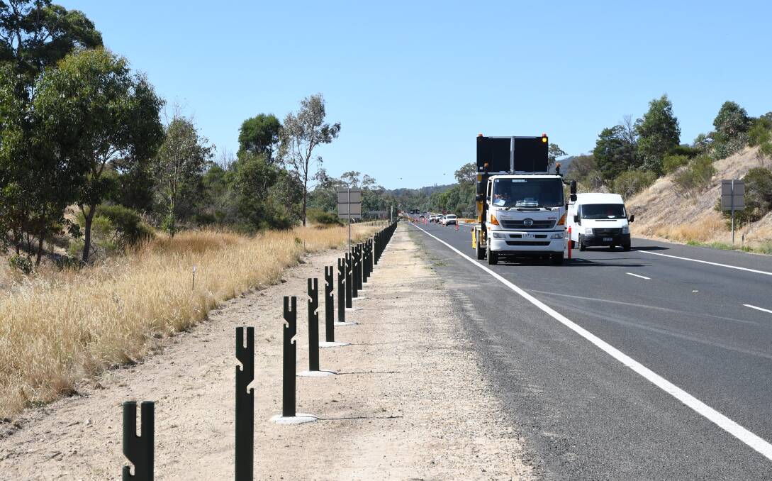 Workers are installing more wire rope barriers on the Calder Highway, such as this site at Ravenswood South. Picture: ADAM HOLMES