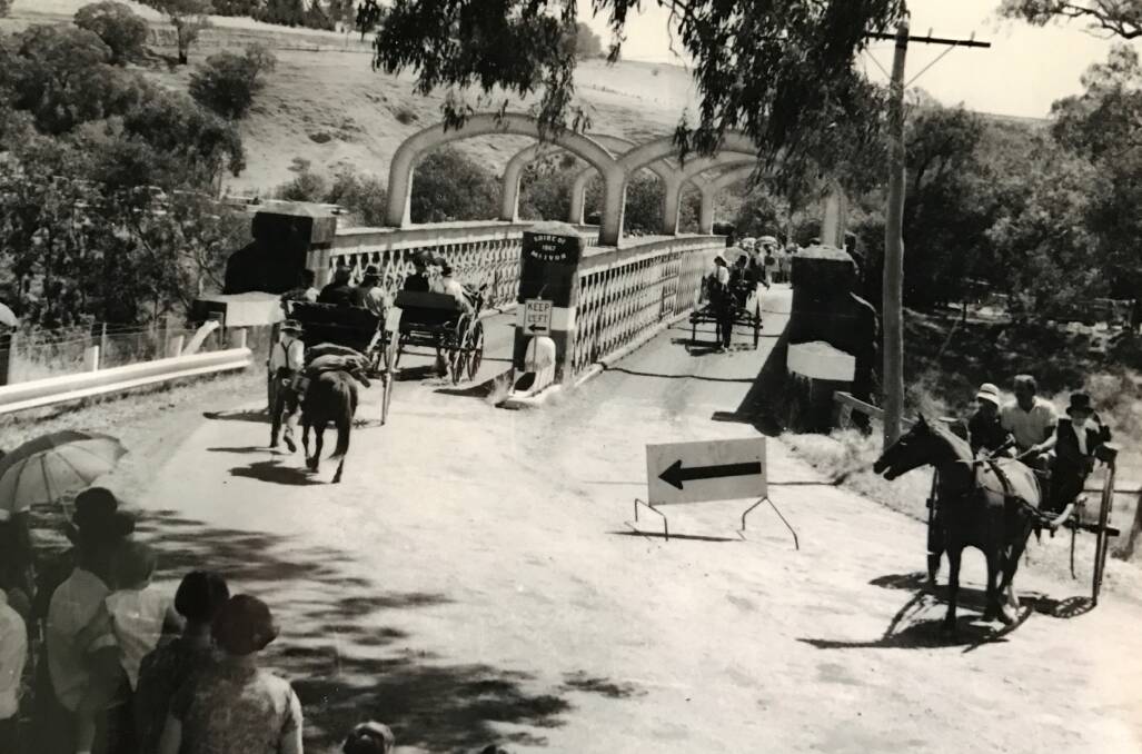 Horse-drawn carriages cross the bridge during its 100-year celebrations in 1968.
