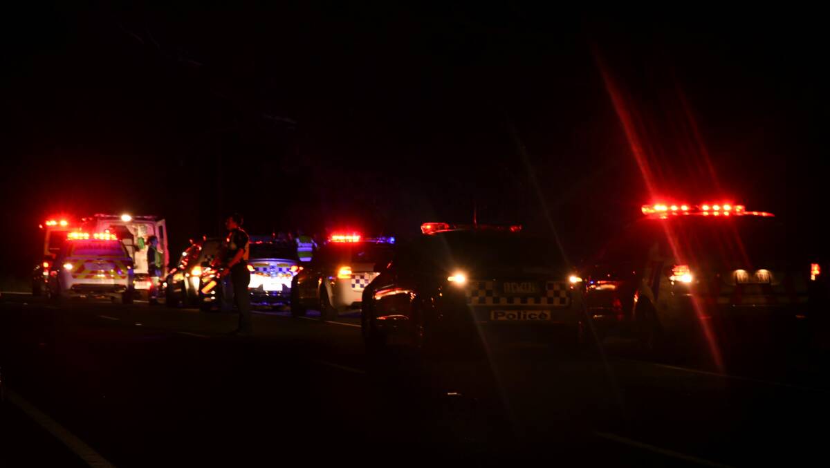 Police direct traffic on the Calder Highway at Kangaroo Flat on Friday night.