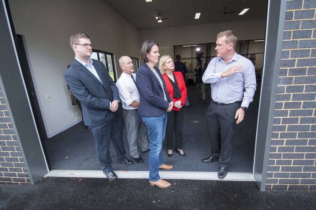 Coalition candidates for Bendigo East and Bendigo West discuss the plans - just outside the driving rain - with Epsom Primary School council president Scott Jefferis. Picture: DARREN HOWE