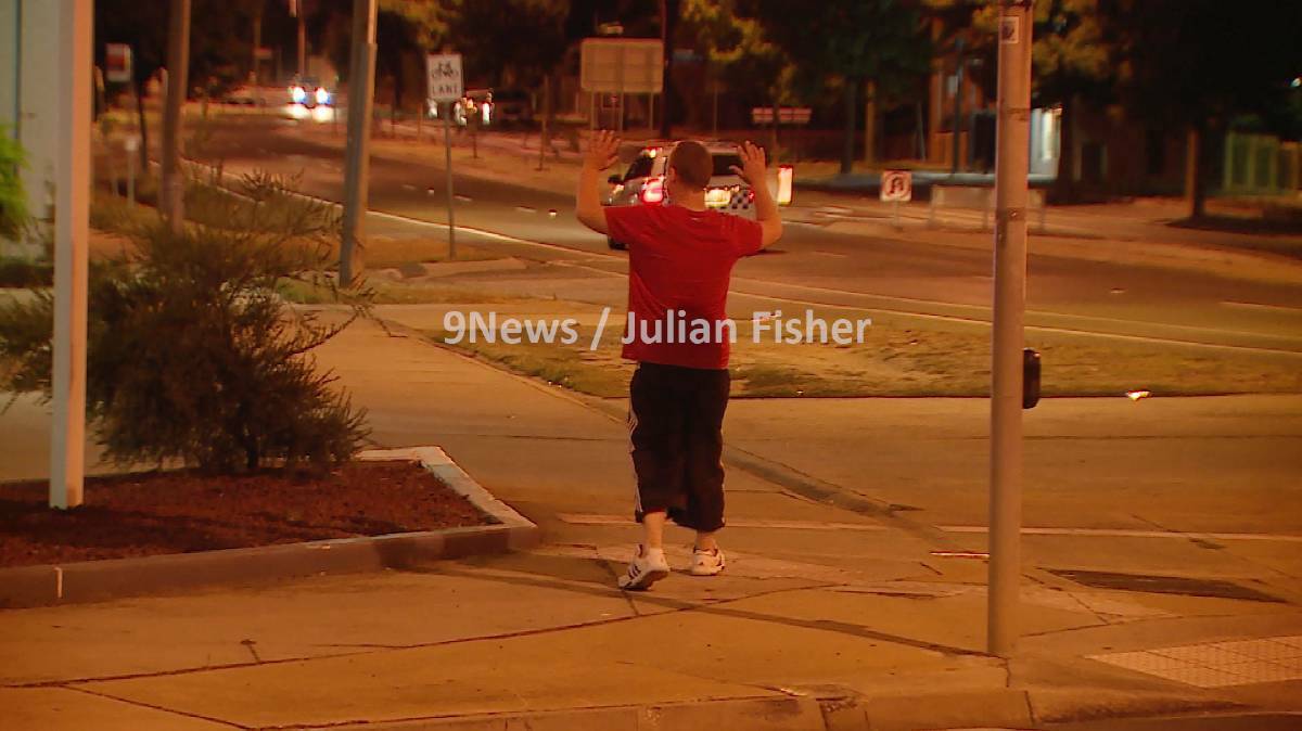 Tyson Gray hands himself in to police shortly after the armed hold-up of Coles Express service station on McIvor Road. Picture: 9News/Julian Fisher