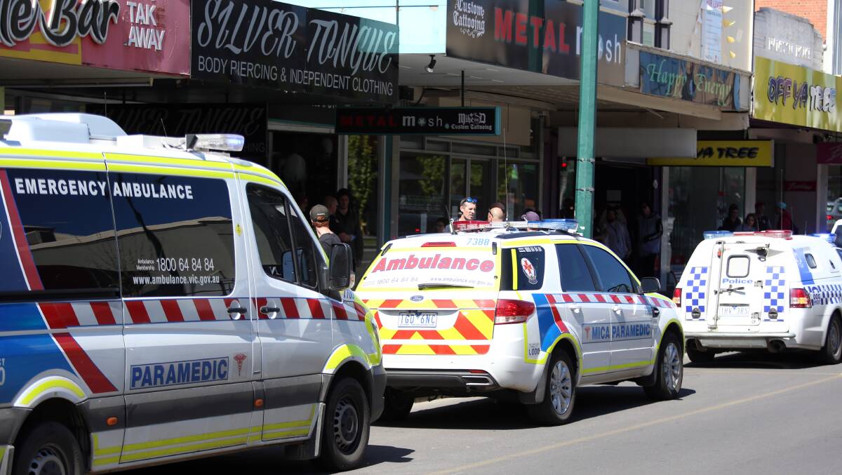 Emergency services at Metal Mosh on Mitchell Street where the victim sought medical attention. Picture: GLENN DANIELS