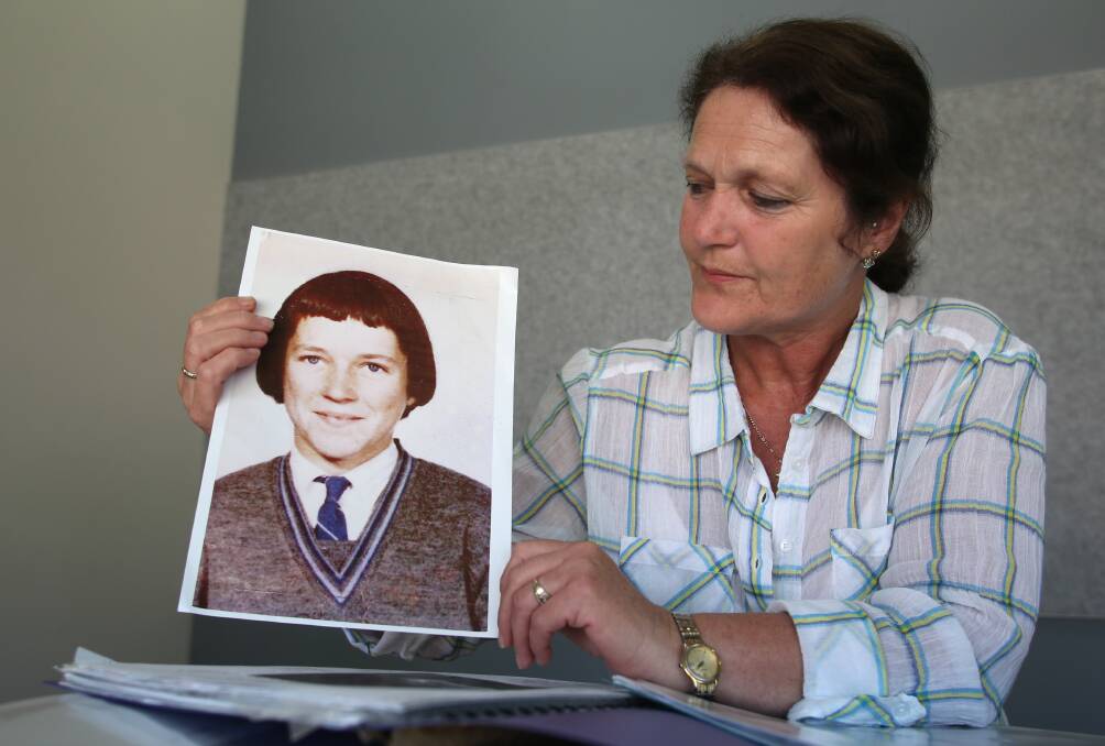 Lyn Ireland holds an image of her sister Maureen Braddy. Lyn was 8 years old when Maureen went missing. Picture: GLENN DANIELS
