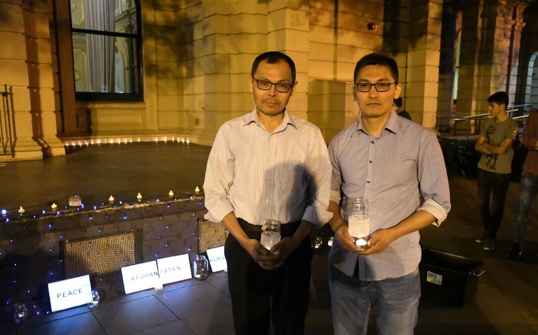 Bendigo Hazara community leaders Mohammed Azimi and Danial Lomani at the candlelight vigil on Friday night. Picture: ADAM HOLMES
