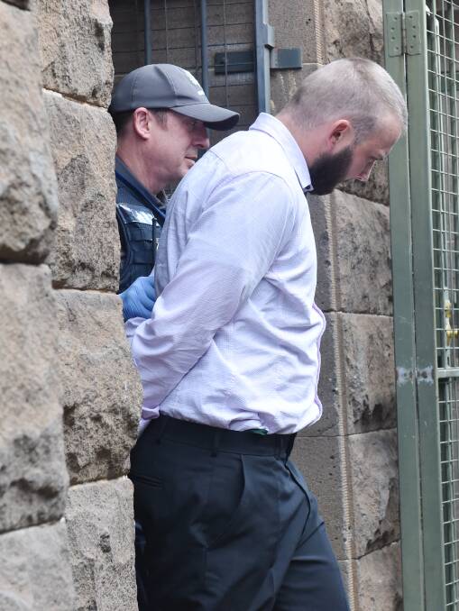 Joby Rowe is escorted from the court after being sentenced for child homicide. Picture: DARREN HOWE