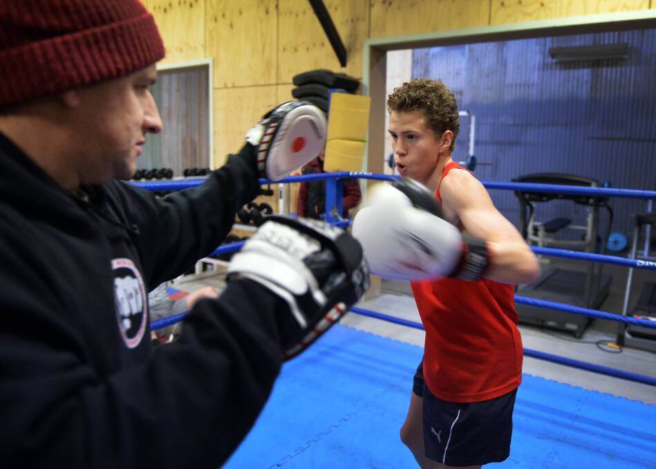 ONE-TWO: Tully Scanlon strikes the pads held by trainer Danniel Burton at Hit Factory boxing gym in Golden Square. Picture: BRENDAN McCARTHY