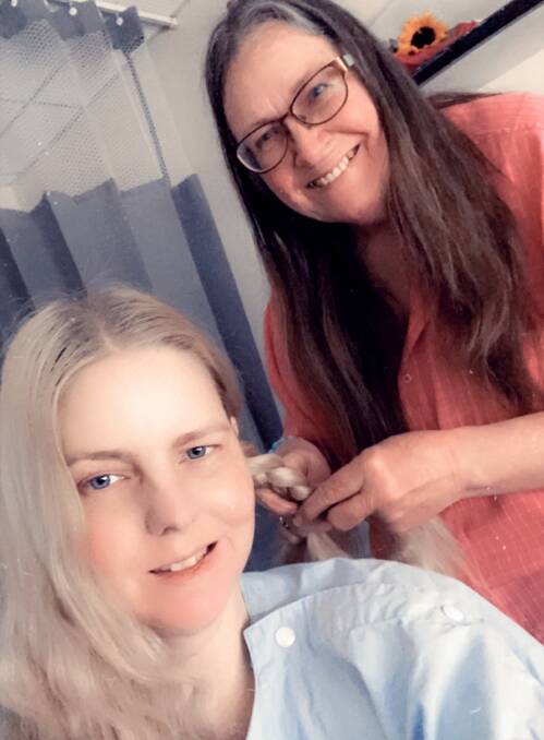 Julie plaiting her daughter Nyree's hair in hospital.