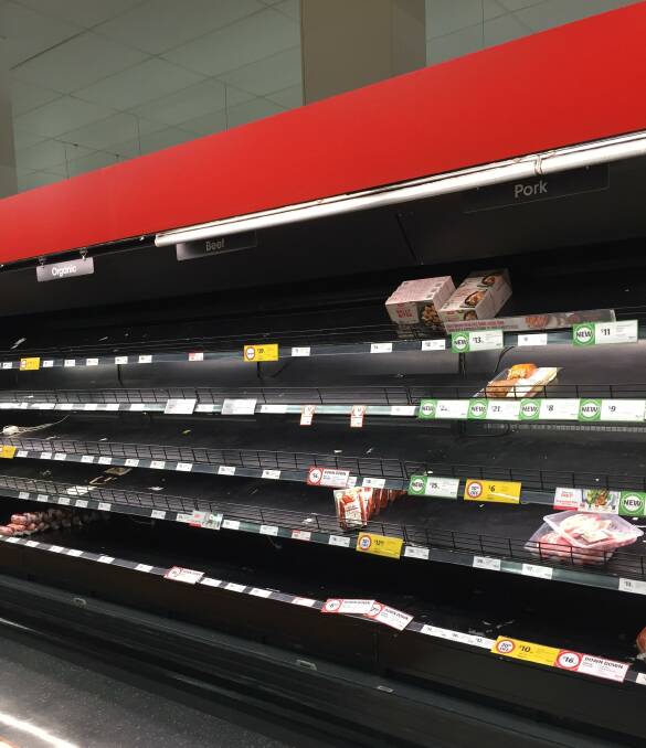 BARE SHELVES: Panic buying has hit Coles, with meat cabinets being stripped nearly bare.