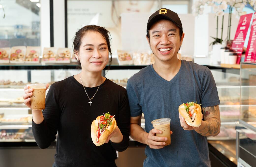 Rutherford's M&M Bakehouse owners Melissa Do and Patrick Vu with a traditional Banh Mi and a crispy Banh Mi, and Vietnamese iced coffees. Photo: Max Mason-Hubers