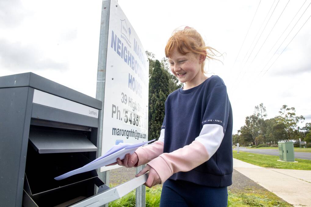Phoebe England pops a spot of sunshine in the Marong Neighbourhood House letter box. Picture: DARREN HOWE