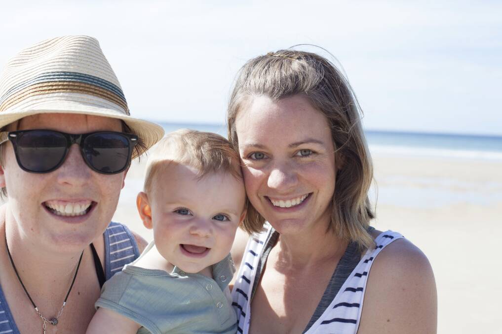 Elisha and Emily with their son Liam, almost a year after the same-sex marriage survey result was announced. Picture: SUPPLIED
