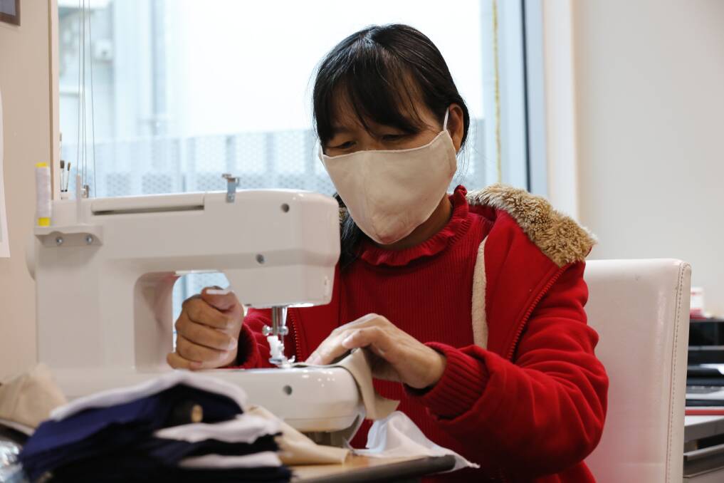 HARD AT WORK: Khin Khin using a sewing machine to make a reusable cloth face mask. Picture: EMMA D'AGOSTINO