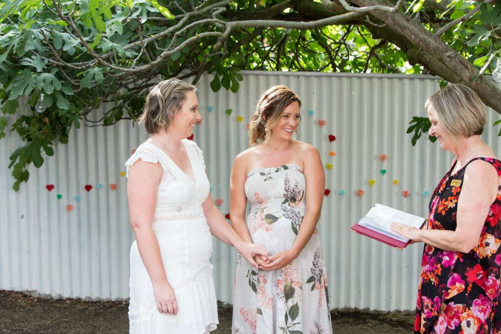 Elisha and Emily are married by celebrant Rosemary Taylor. Picture: KIRRALEE WEDDINGS