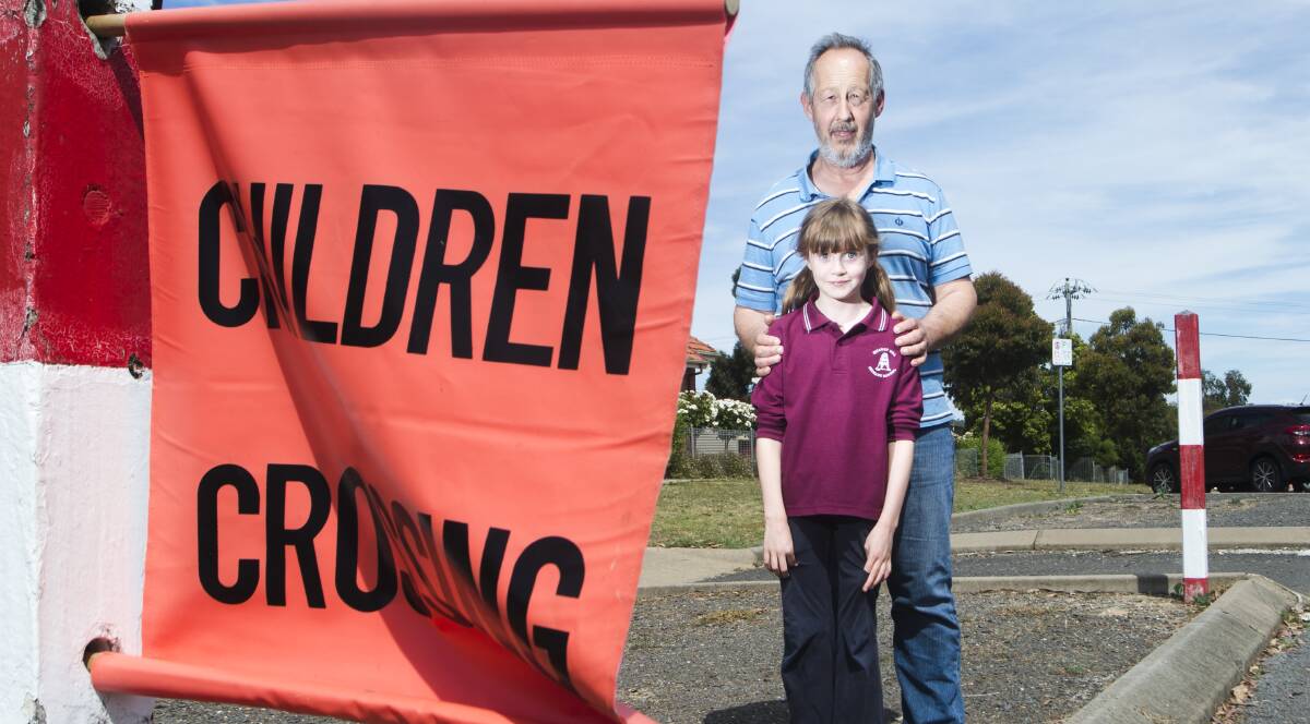 CHANGE SOUGHT: Quarry Hill Primary School parent Tony Smith and his daughter Emma at the Peel Street crossing, which is no longer supervised. Picture: DARREN HOWE