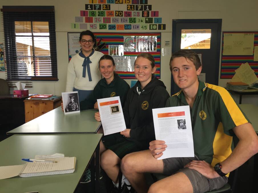 Sarah Clare with Jasmine Condliffe, Rylee Gallagher and Jack Sinclair of the East Loddon Remembers team. The students are holding research they compiled for the online project. Picture: EMMA D'AGOSTINO
