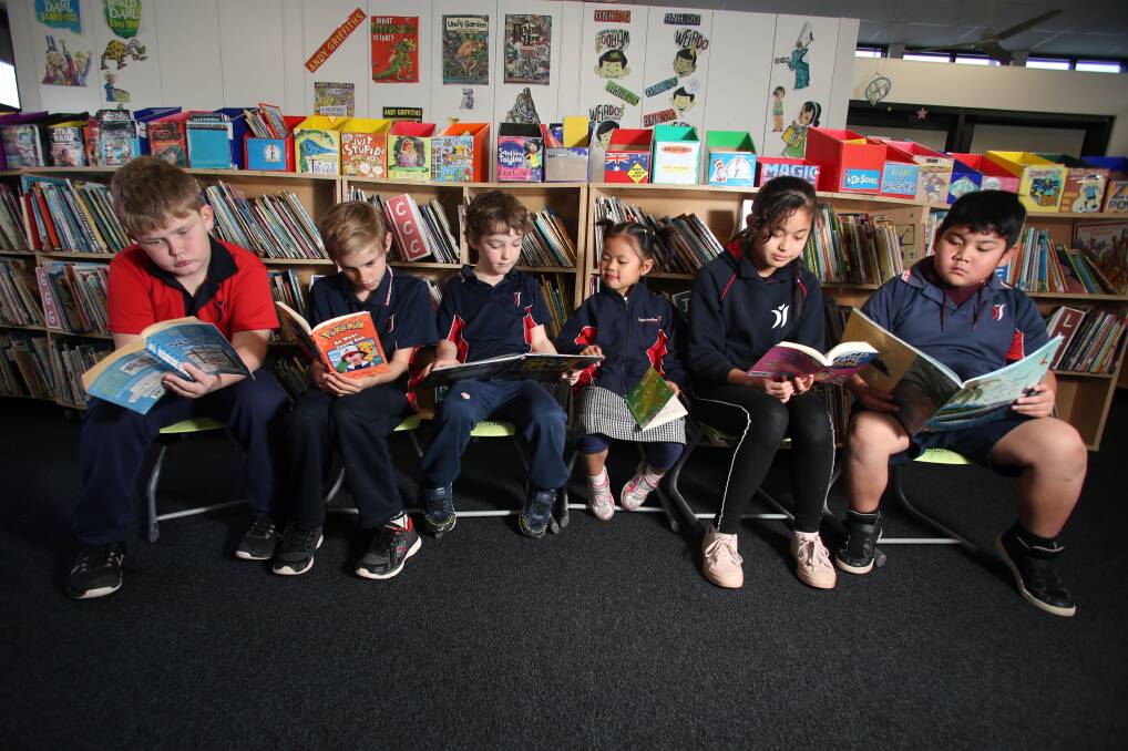Kegan Lock-Munro, Conna Robins, Trystan Waters, Elizabeth Maung, Than Than Nwe and Jacob Welwah take some time out to read. Picture: GLENN DANIELS