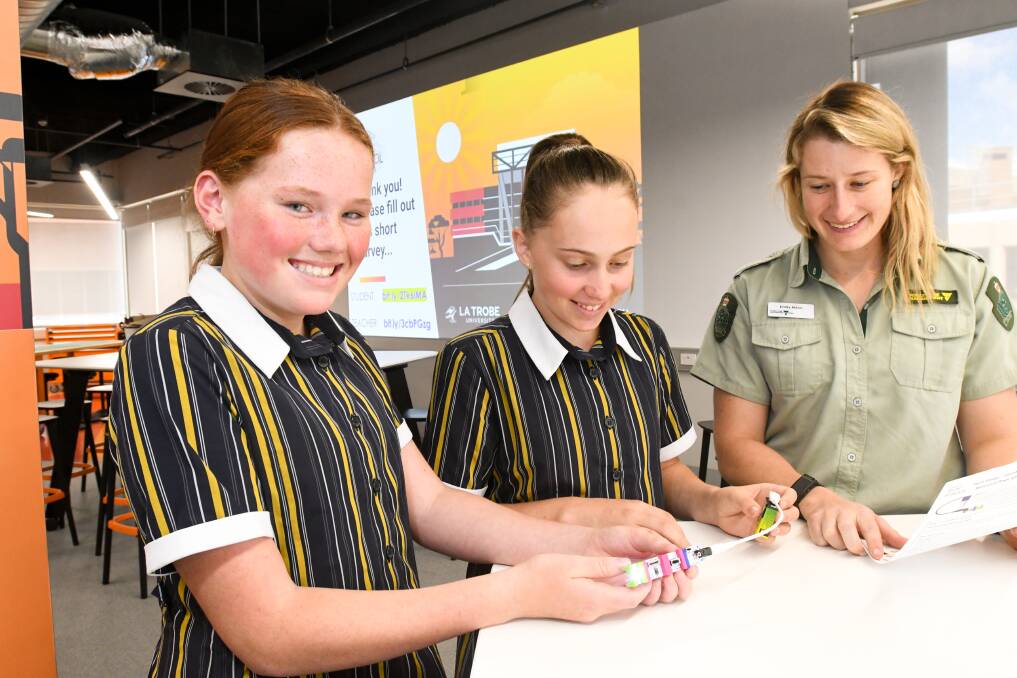 Catherine McAuley College students Ava Perry and Amelia Boase with Department of Environment, Land, Water and Planning fire planner Emily Atton. Picture: NONI HYETT