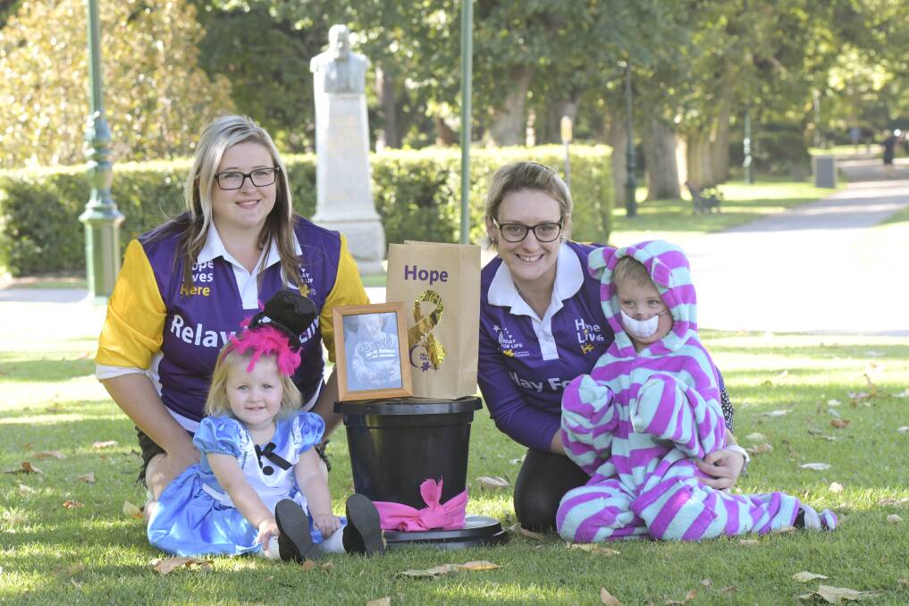 Members of Relay for Life Bendigo team 'Mad Hatters' - Amie Wilson, Laihton Ridgeway, Paige and Archie Cartwright - prepare for tonight's event. Picture: NONI HYETT