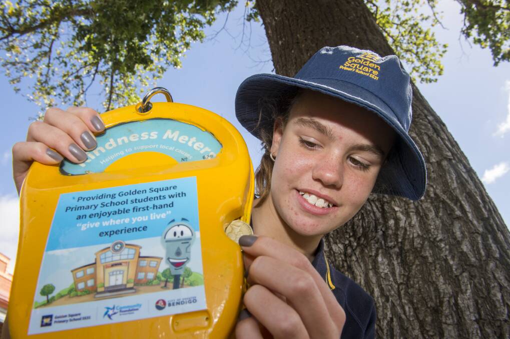 Golden Square Primary School student Jasmine Reilly makes a donation to the new Kindness Meter outside Grocery Express at Panton Street. Picture: DARREN HOWE