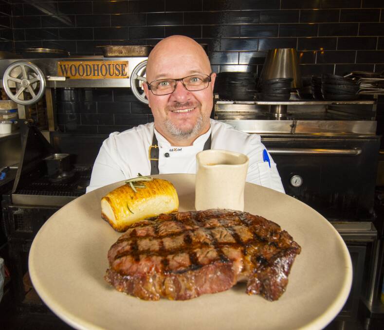 The Woodhouse head chef and owner Paul Pitcher with a Cohuna Wagyu scotch fillet well before the outbreak of COVID-19, celebrating an award. Picture: DARREN HOWE