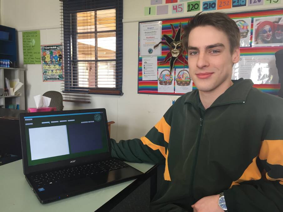 Ethan Lewis with the website he created during software development studies.
