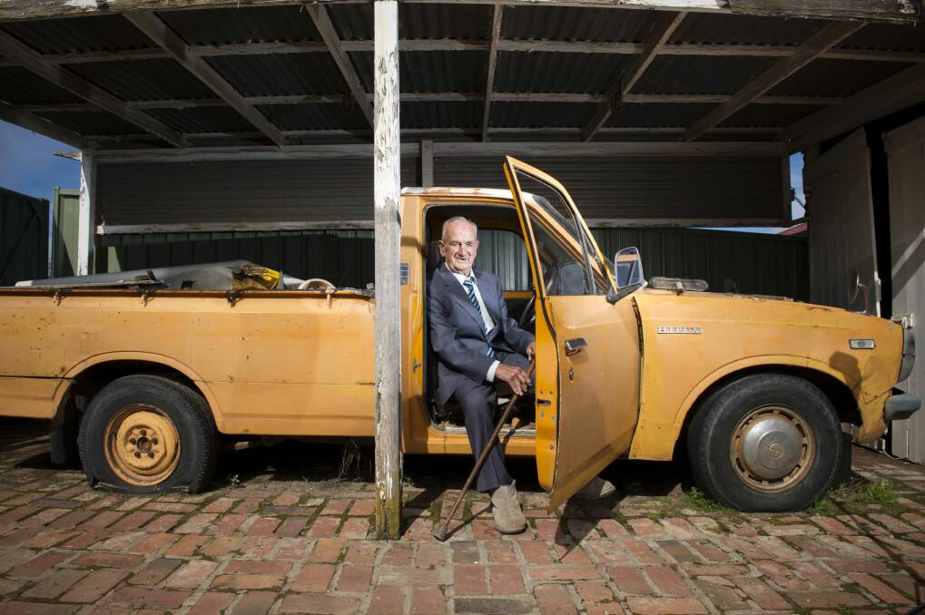 Harold "Wicky" Toma with his beloved orange ute on his 100th birthday. Picture: DARREN HOWE