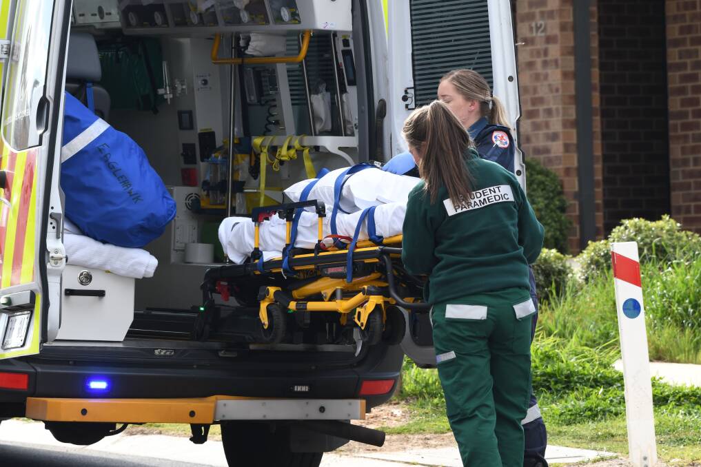 Paramedics attend he scene of an injury in Jackass Flat. Picture: NONI HYETT