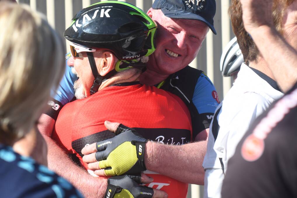 Graeme Lowndes hugs Edward Barkla during the Lap for Lowndesy in 2018. Picture: NONI HYETT
