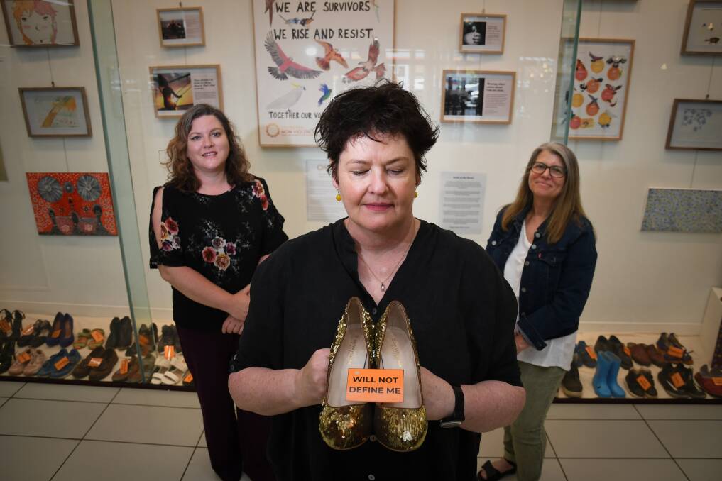 Annie North's Michelle Long, Centre Against Sexual Assault Central Victoria's Kate Wright and Centre for Non-Violence's Yvette Jaczina at the exhibition in Fountain Court. Picture: NONI HYETT