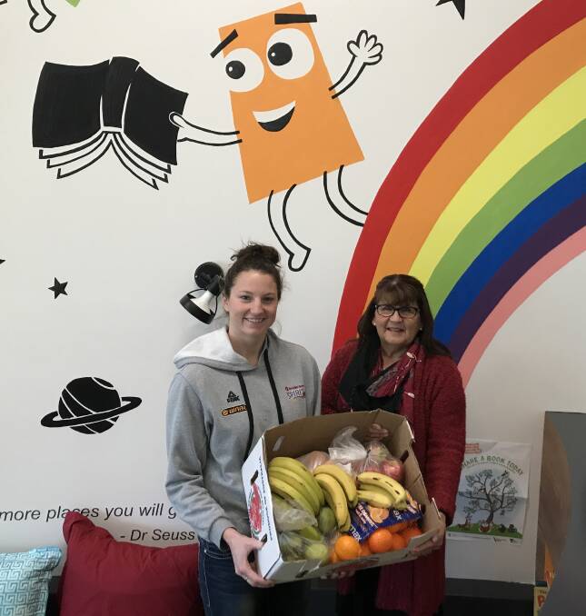 FRESH FRUIT FRIDAY: McKern Foundation ambassador Kelsey Griffin delivers fresh fruit to Bendigo Community Health Services family day care resource worker Robyn Knight. Picture: CONTRIBUTED