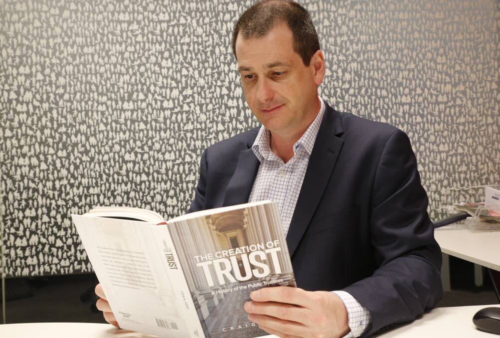 State Trustees chief executive officer Craig Dent with his book, The Creation of Trust. 