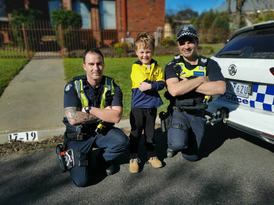 Astin Harvey celebrating his seventh birthday with two of the Bendigo Police Station's finest. Picture: SUPPLIED