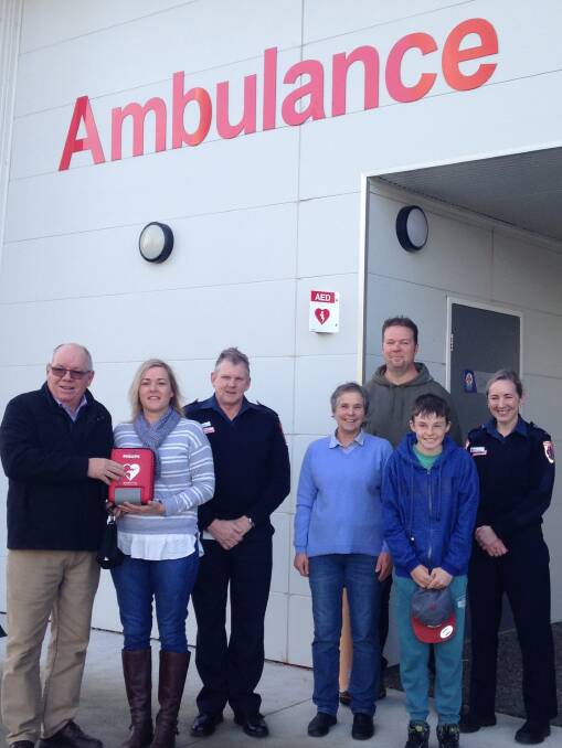 Kyneton Ambulance Auxiliary treasurer Kieran McGrath, auxiliary president Levina Bell, Ambulance Victoria Loddon group manager Tony Walsh, auxiliary secretary Helen Parker, paramedic and auxiliary vice-president Dave Van Egmond, Ben Van Egmond, and Kyneton team manager Eileen Henderson with the new defibrillator. Picture: SUPPLIED
