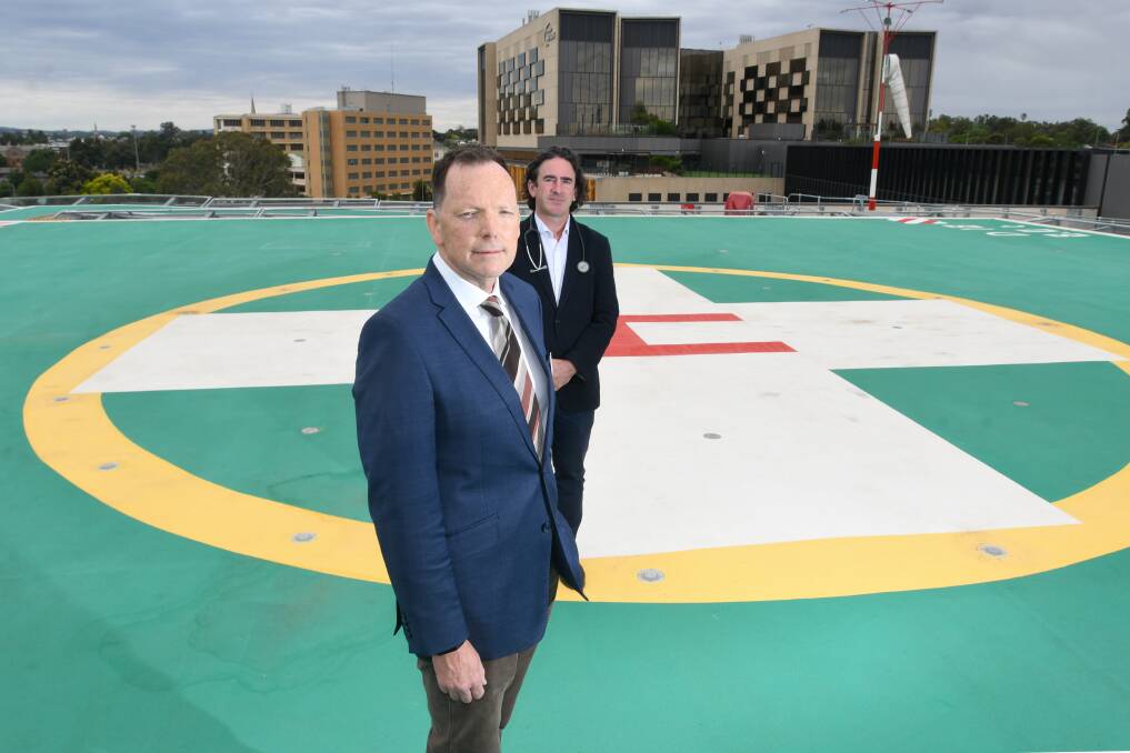 Bendigo Health chair Bob Cameron and emergency department clinical director Dr Simon Smith on the hospital's helipad, which is on track to record 150 visits this year. Picture: NONI HYETT