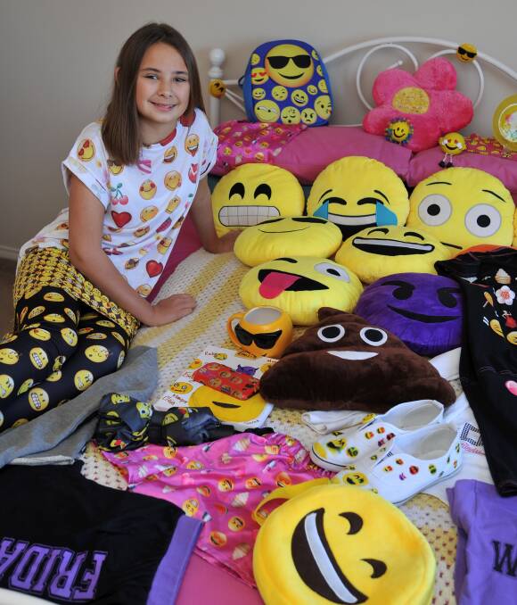 Emoji queen: Laura Rasmini has a bedroom brimming with emoticon merchandise - from pillows to magnets to a full outfit of emoji clothing. World Emoji Day is celebrated annually on July 17. Picture: Lachlan Bence