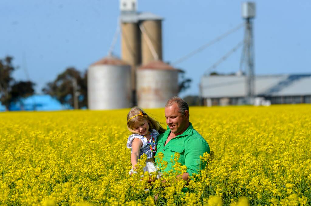 Farmer Eric Hocking and his daughter Amber check over the family's canola crop at Tandarra. Picture: DARREN HOWE