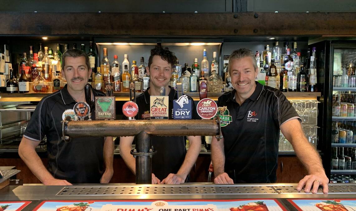 Luke Macumber, Zacc Alexander and Scott Macumber share a mo-ment at the Brougham Arms Hotel.