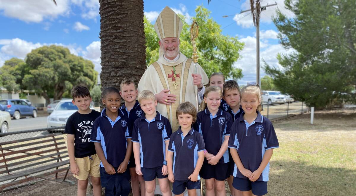 Bishop Shane Mackinlay and students from the parish school. PHOTO SUPPLIED