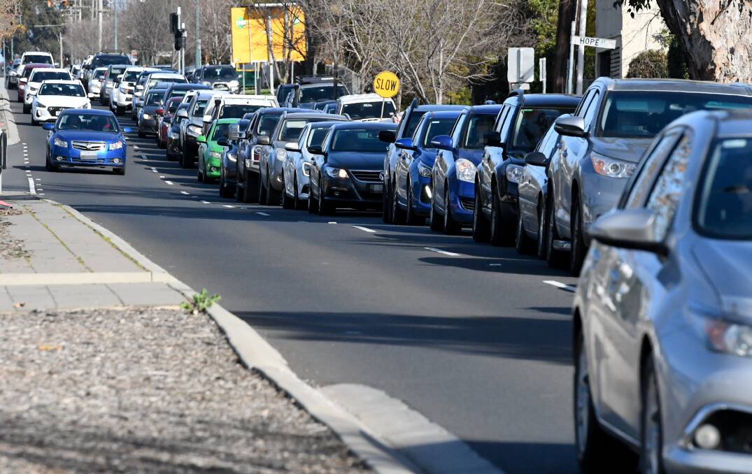 Traffic banks up as drivers wait to be tested this week.