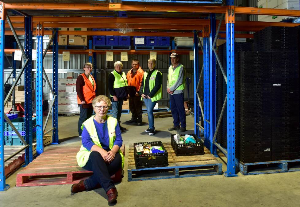 Cathie Steele (front) with Mary James, Joanne Michell, Jamie Bertus, Anne Constable and Adrian Dole in the warehouse of Bendigo Foodshare. Photo: Brendan McCarthy 