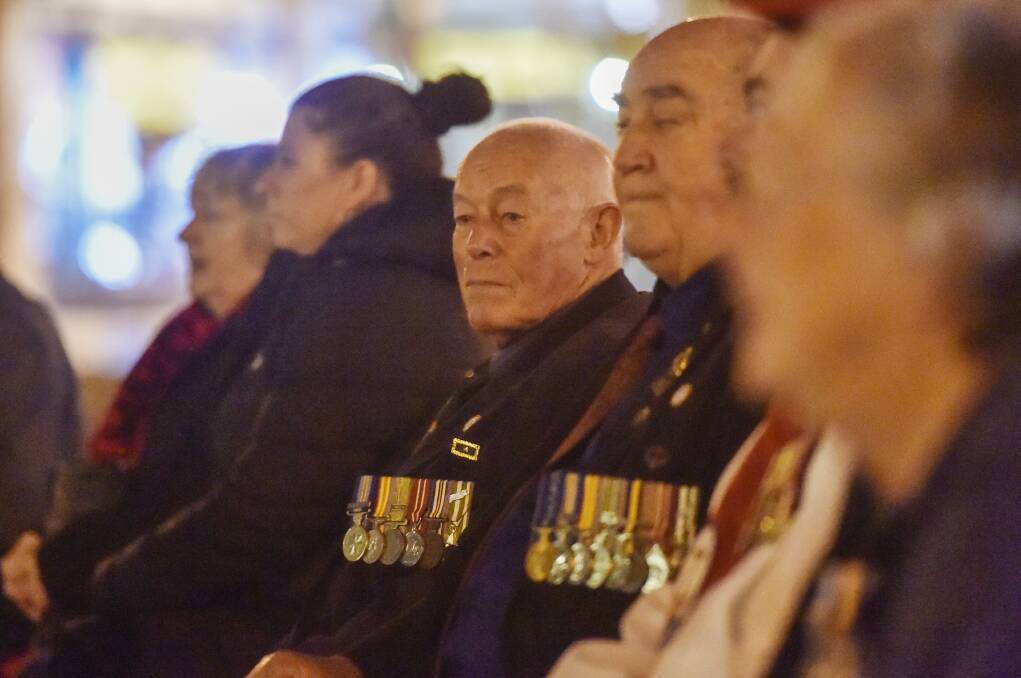 HONOUR: About 60 people attended the early morning service. Picture: DARREN HOWE