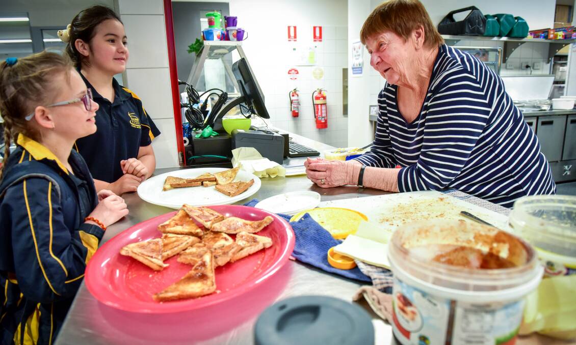MORNING CATCH-UP: Breakfast Program co-ordinator Marg Rogers chats with Kalianna School students Courtney Schreiber and Sam Fitton. Photo: Brendan McCarthy.