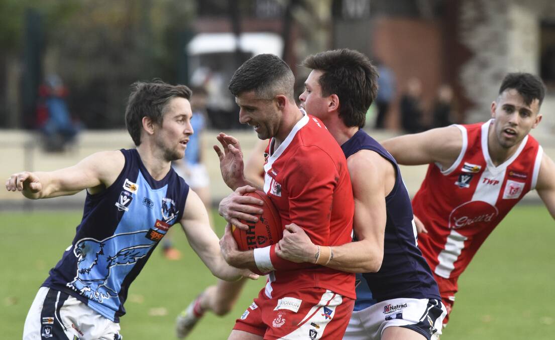 South Bendigo coach Nathan Horbury is wrapped up in a tackle. Picture: NONI HYETT