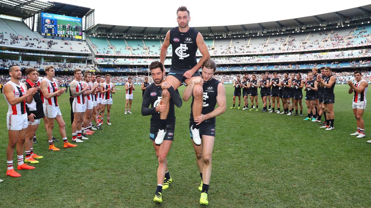 Andrew Walker is chaired from the field after his last AFL game.