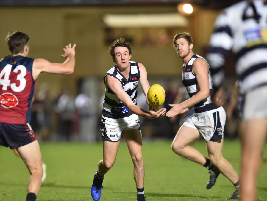 SUPERB STORM: Strathfieldsaye's Jack Neylon dishes off a handball during the Storm's 46-point victory over Sandhurst at the QEO on Friday night in round two of the BFNL. Picture: GLENN DANIELS