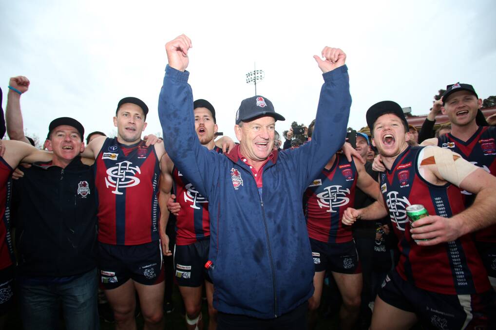 HARD WORK PAYS OFF: Sandhurst coach Wayne Primmer leads the Dragons' celebrations after they beat Golden Square by 32 points in the 2016 BFNL grand final.