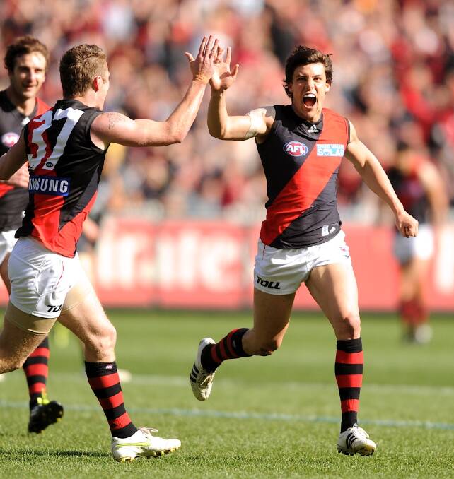 BIG STAGE: Angus Monfries celebrates a goal for Essendon in a 2011 elimination final against Carlton at the MCG. It was one of 150 games he played for the Bombers.