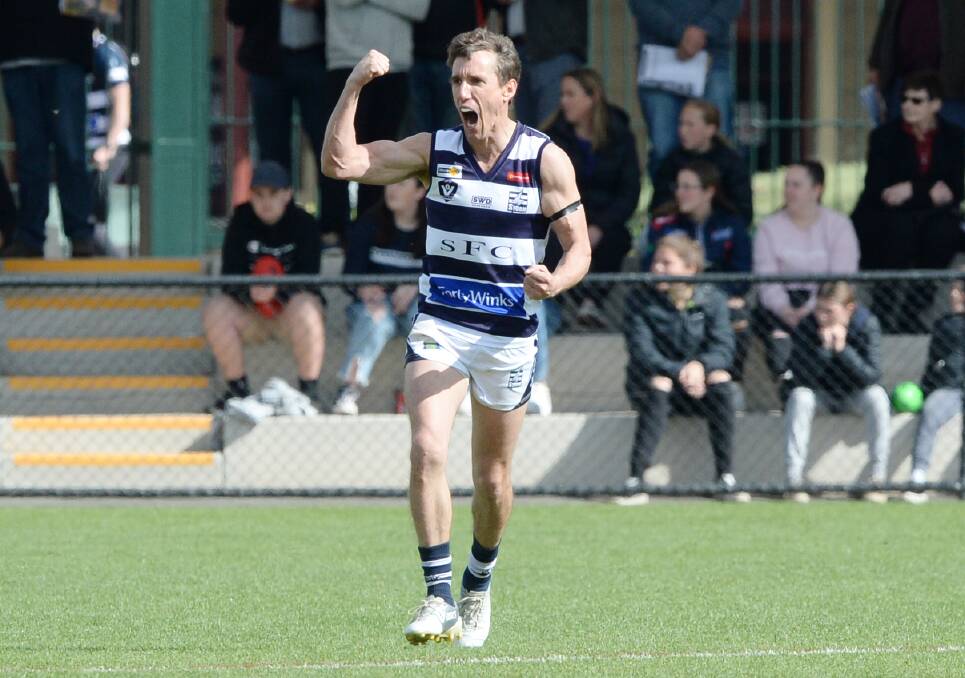 UP AND ABOUT: Strathfieldsaye coach Troy Coates celebrates one of his three grand final goals against Eaglehawk on Saturday. Picture: DARREN HOWE